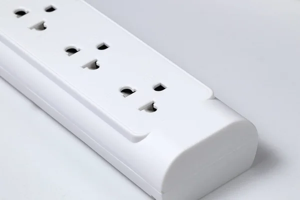 Closeup of electrical power strip or extension block on white background.