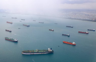Aerial view of the Singapore Strait, Ocean liner, tanker and Cargo Ship with rainstorm in Singapore Strait, View from plane. clipart