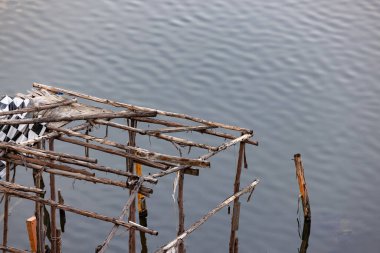 abandoned molder wooden house, Ruins of wood buildings near the shore of the lake.