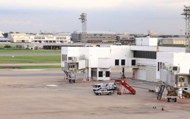 Mobile Passenger Boarding Stairs move for services at Apron near aircraft bay. clipart