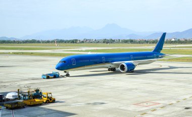 Uçaklar uçak römorkörleri tarafından taksiye geri itilir..