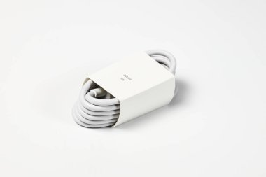 Yeni beyaz USB tipi şarj kablosu, birçok aygıt için uyumlu, sarmal bir şekle bürünmüş, beyaz arkaplanda izole edilmiş.