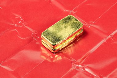 Asya 'da perakende alım satımında kullanılan kırmızı kağıtta gerçek altın külçeler ya da külçeler vardı..