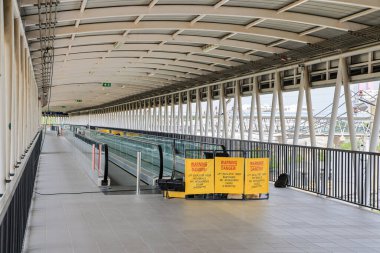 repair in progress sign near an Escalator or Travelator, Sign showing warning of caution maintenance process, Yellow sign that alerts for repair equipment zone.