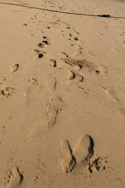 Human footprints on the beach sand (white sand).