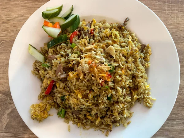 Local food from Indonesia. Fried white rice, mixed with spices, vegetables and lamb. Called \