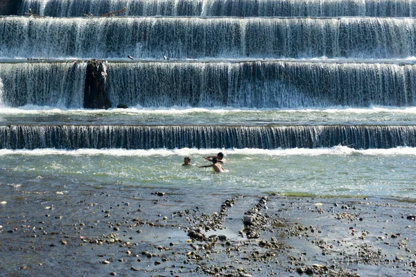 Klungkung, Bali, Endonezya (10 Temmuz 2021): Barajda suyla oynayan mutlu çocuklar. Adı 