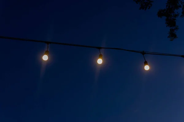 Rows of aesthetic lights against a blue sky background