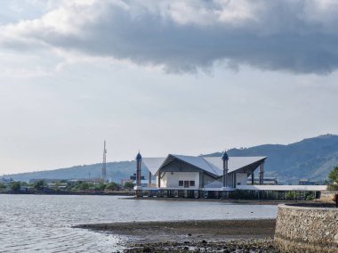 The mosque stands majestically on the beach. Amahami Beach in Bima City clipart