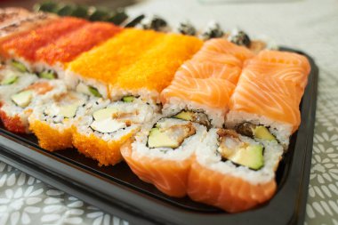 Assorted sushi nigiri and maki big set on slate. A variety of Japanese sushi with tuna, crab, salmon, eel and rolls. Top view