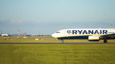 Dubli, İrlanda - 10.11.2021: Dublin havaalanında Ryanair uçağı. Ticari uçak jeti güzel gün batımı ışığında iniyor. Uçuş ulaşımı havayolu arka planı kavramı.