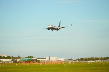 Dubli, İrlanda - 10.11.2021: Dublin havaalanında Ryanair uçağı. Ticari uçak jeti güzel gün batımı ışığında iniyor. Uçuş ulaşımı havayolu arka planı kavramı.