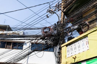 Intertwined electric wires in front of buildings which is the first priority problem to solve in Bangkok.