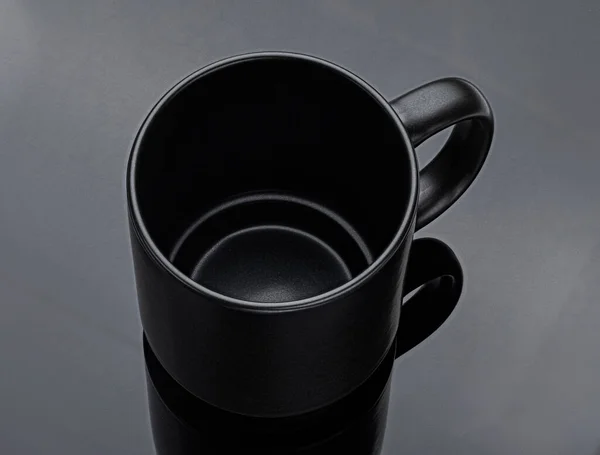 Black mug isolated, full depth of field. Black cup on black background, top view
