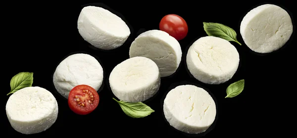Falling Mozzarella Cheese Slices Tomato Basil Leaves Isolated Black Background — Stock Photo, Image