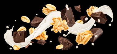 Düşen yulaf lapası, süt sıçraması ve siyah arka planda izole edilmiş çikolata parçaları, paket tasarım elementi.