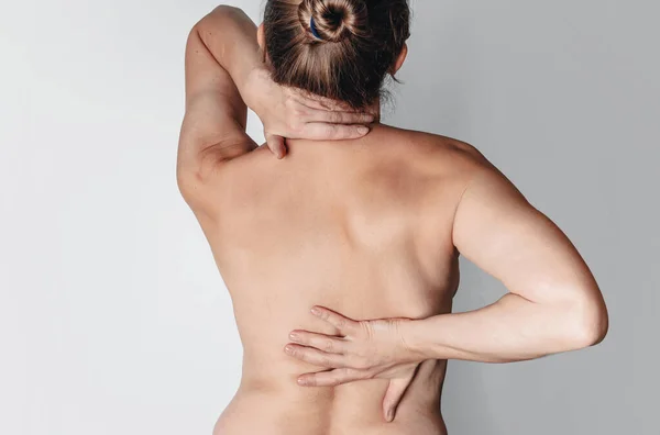 Scoliosis. Back ache . Naked female back. Pain in kidneys.