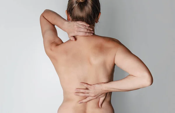 Scoliosis. Back ache . Naked female back. Pain in kidneys.
