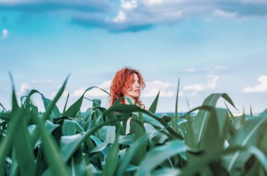 Head red woman over corn leaves