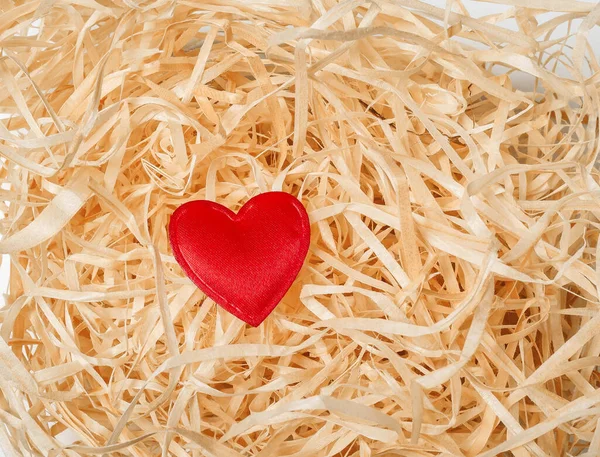 One red heart on decorative wood chip. Solitude. Love. Valentine\'s Day.