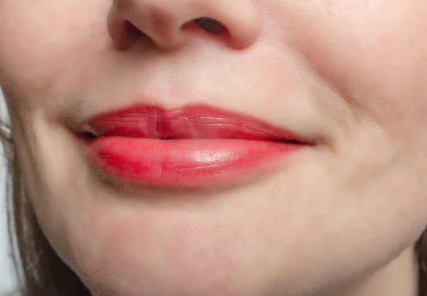 Female natural lips close-up. Smile. Enlargement, correction of lips
