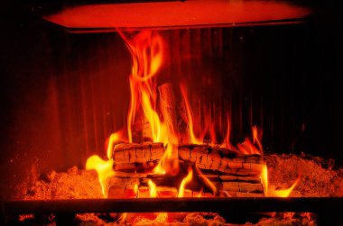 Fire in the fireplace. Firewood is burned in a home oven