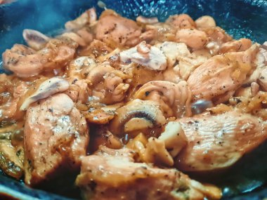 Healthy home made delicious chicken meat cooked with fresh mushrooms, onion and herbs, keto food