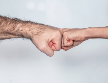 two hands man and woman giving fist bump