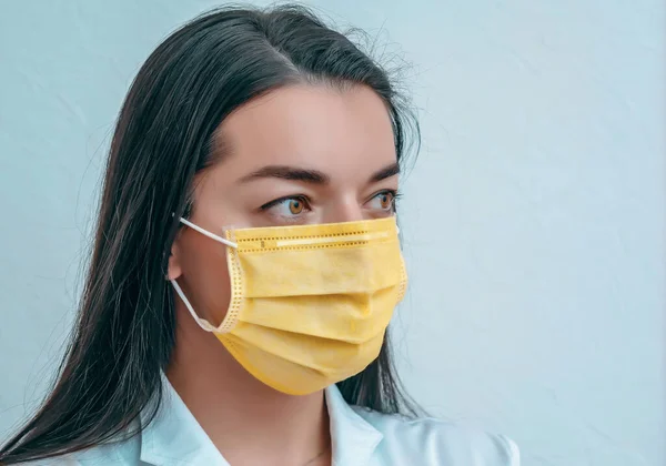 Portrait of a doctor woman in a yellow mask coronavirus epidemic