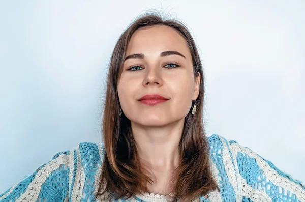 stock image Dark-haired smiling woman looking at camera. Blue lace blouse. White background