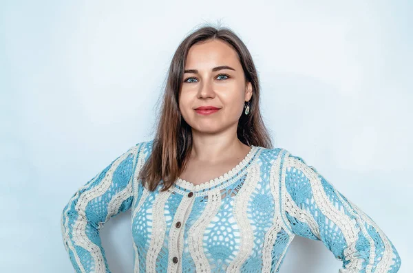 stock image Smiling woman looking at camera. Hands on sides. Blue lace blouse. White background