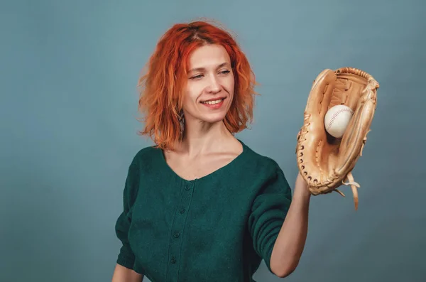 Happy woman caught a baseball in baseball leather gauntlet