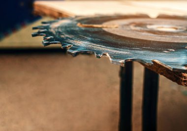 Marangozluk atölyesindeki yuvarlak testere kahverengi arka planda..