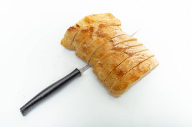 Slices of fresh bread and cutting knife on white background, isolated. Healthy proper nutrition.