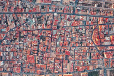 From high above, the ancient city sprawls like a labyrinth of miniature dwellings, each one snug against its neighbor, forming a patchwork of rooftops that stretch to the horizon. clipart