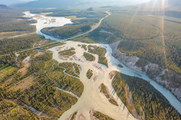 stock image Drone footage of winding river during flood in sunlight. Forest, rocks. Nordegg, Alberta, Canada