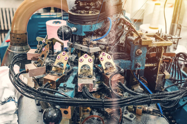 Clear view of sock knitting machine in operation. Machinery and equipment in textile production. Production process