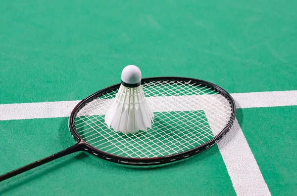 shuttlecock on badminton racket in badminton court