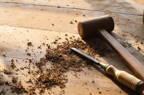 wooden hammer and chisel on the wooden table