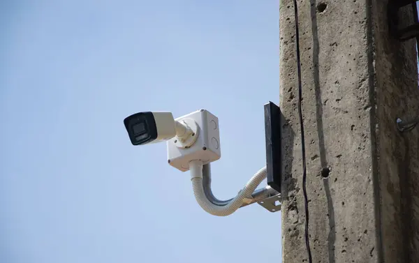 CCTV surveillance security camera video equipment on pole outdoor building safety system area control and copy space