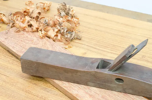 stock image Shavings after planing of wood ash on the background of the plane close up.DIY concept. Woodworking and crafts tools. Carpentry hand tools. Wooden