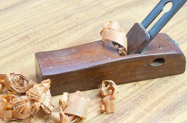 stock image Shavings after planing of wood ash on the background of the plane close up.DIY concept. Woodworking and crafts tools. Carpentry hand tools. Wooden