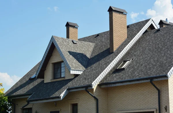 House asphalt shingles rooftop with dormer window, attic skylights, rain gutter, soffits, roof vents.