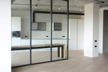 KYIV, UKRAINE - November, 21, 2023: Glass kitchen wall, glass room divider, partition with squares is a perfect solution for small spaces.