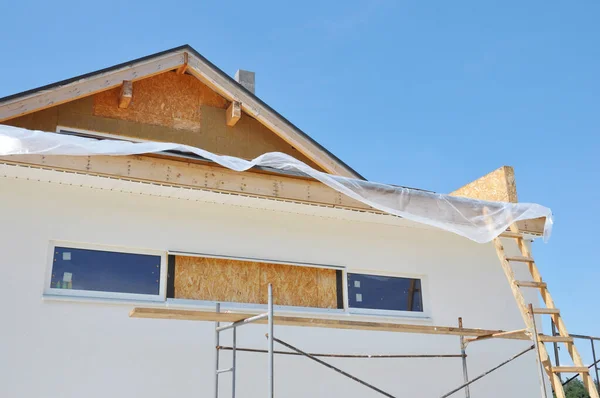 Attic insulation. House wall facade insulation, painting walls, roofing construction, installing soffits boards, fascias. House wall insulation for comfort energy saving and energy efficiency