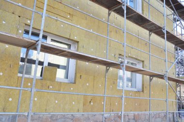 Ev enerjisi tasarrufu için dış duvar üzerine mineral yünü yalıtımı kuruluyor.