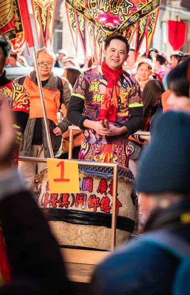 Madrid, Spain; 22nd January 2023: Participants of the Chinese New Year parade, dressed in traditional costumes and symbols, in Madrid. Spain. One of them carrying a traditional Chinese drum