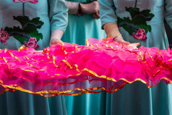 Madrid, Spain; 22nd January 2023: Chinese New Year parade in Usera neighborhood, Madrid. Spain. Participating women dressed in traditional light blue costume displaying pink frilly fans.