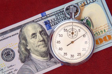 mechanical stopwatch on the background of dollars. Part time accuracy for business. business and finance time.