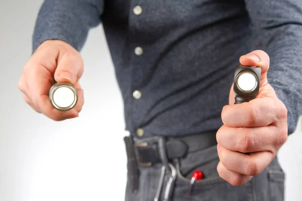 stock image man holds a flashlight in his hand. item for camping and household life